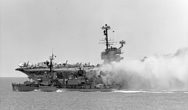 The destroyer USS Rupertus comes alongside Forrestal to help fight the fires (US Navy)